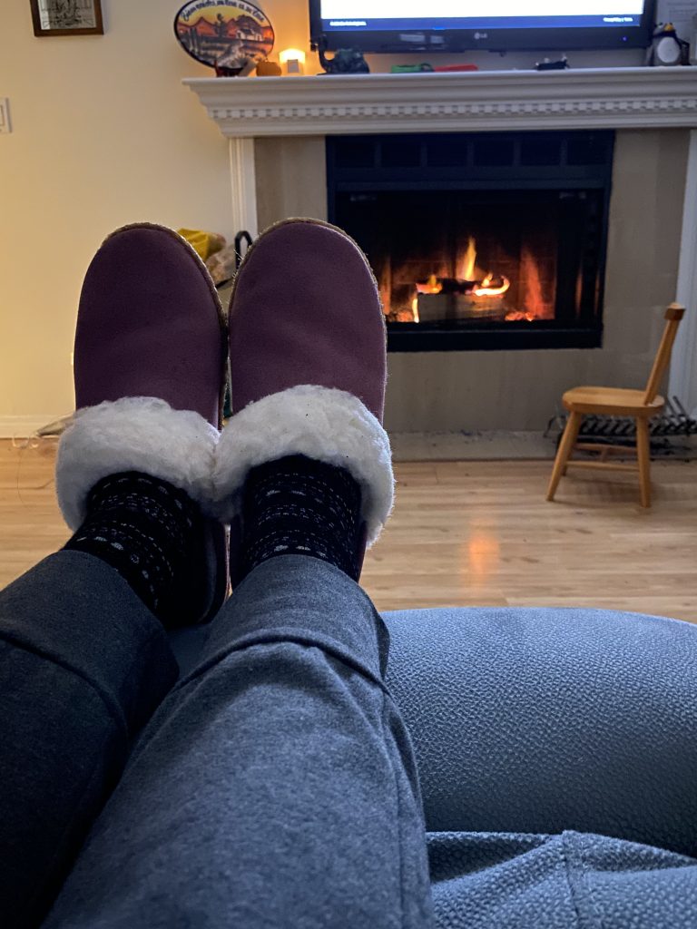Feet up in slippers by the fireplace. Favourite cozy things