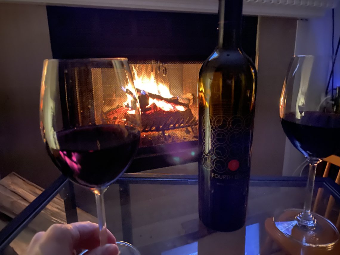Wine Thursday TIME winery Fourth Dimension wine in front of a fireplace